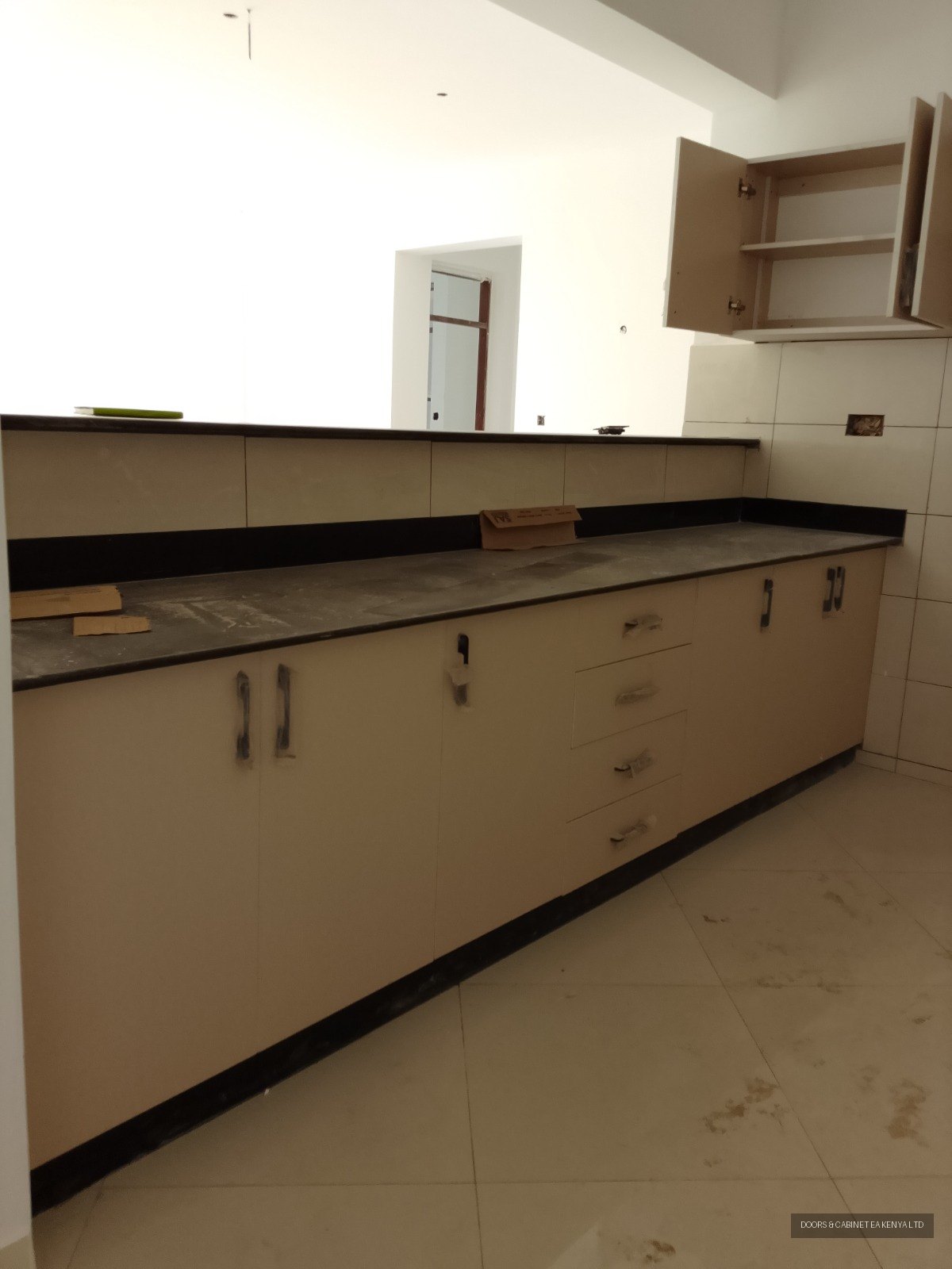 Cream Kitchen with Black Granite Top — Kitchen Cabinets by Doors and Cabinet EA, Mombasa